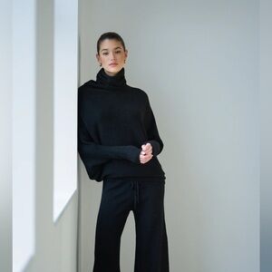 JAKI London-Asymmetric Draped Roll Neck in Black Seamless Knit